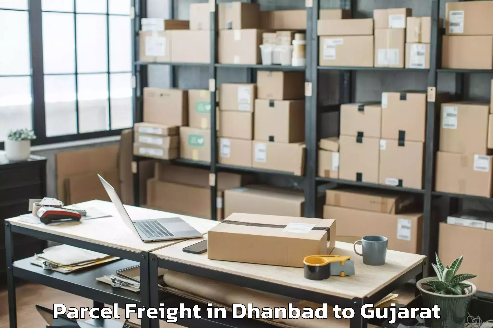 Book Your Dhanbad to Tilakwada Parcel Freight Today